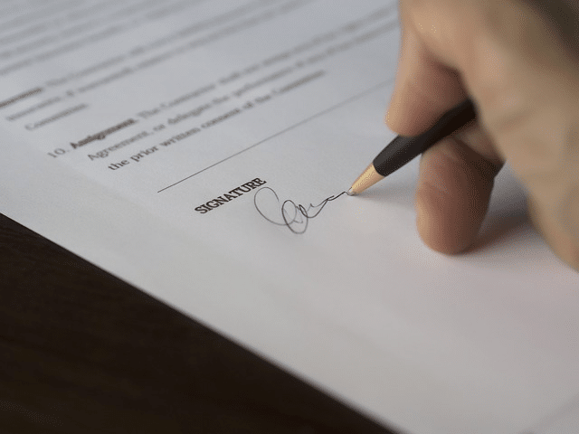 pen signing paper
